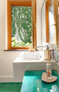 un bagno con un lavandino bianco e una finestra di Villa D'apuzzo nel cuore di Positano a Positano Altre 37 foto