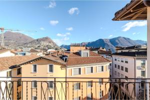 a view from a balcony of buildings and mountains at Novos Contrada in Lugano