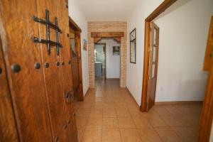 a hallway with wooden doors and a tile floor at Casa Ana Mari in Conil de la Frontera
