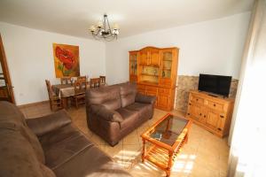 a living room with a couch and a table at Casa Ana Mari in Conil de la Frontera +12 photos