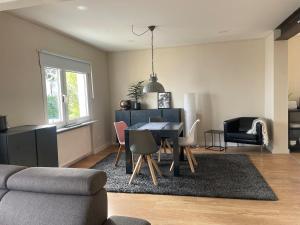 a living room with a dining room table and chairs at 70 qm Wohnung in Neuwied