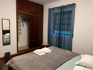 a bedroom with a bed with two towels on it at Azul 31 in Lajes das Flores