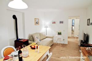 a living room with a couch and a table at Casa Azzurra in Menaggio