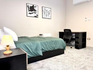 a bedroom with a bed and a desk and a chair at 6th of October Sun & Shade in 6th Of October +27 photos