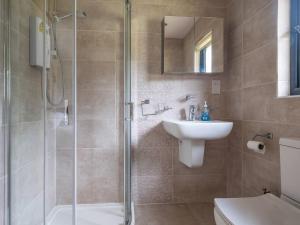 a bathroom with a shower and a sink and a toilet at Cabin W Hot Tub, Outdoor Dining In National Park in Otterburn +45 photos