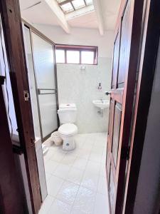 a bathroom with a toilet and a sink at Hospedería Villa Lucía in Villa de Leyva +30 photos