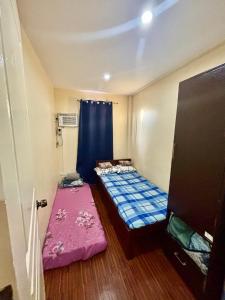 a small room with two beds and a curtain at Affordable Fully Furnished House with 3 Bedroom for Family and Big Groups in Dapitan +33 photos