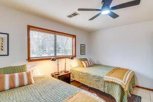 a bedroom with two beds and a ceiling fan at Premier Trout Fishing Scenic White River Cabin in Lakeview
