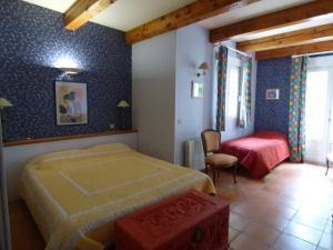 a bedroom with a bed and a desk in it at Villa les muriers in Manosque
