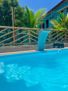 a blue swimming pool with a water slide at Pousada e Restaurante Cenário in Marau