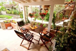 a patio with a table and chairs and flowers at Historic house in Stari Grad