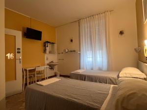 Ліжко або ліжка в номері Hotel Parini