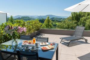 a tray of food on a table on a patio at FeelFree STAYS Basoa in Donostia-San Sebastián
