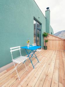 a blue table and a chair on a deck at La Cucina - Hotel & Restaurant in Peggau
