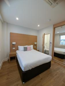 a bedroom with a large bed and a bathroom at House of Fisher - 100 Kings Road in Reading +38 photos