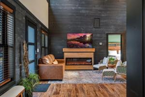 a living room with a fireplace in a house at Sunset in the Glades in Gatlinburg