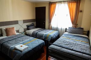 Letto o letti in una camera di Hotel Casa Kolping Quito