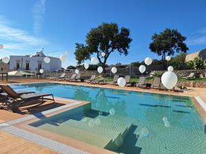 a swimming pool with white balloons in the water at Tenuta Suite 801 in Putignano