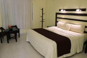 Postel nebo postele na pokoji v ubytování Hotel Nututun Palenque