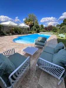 a swimming pool with two chaise lounges next to at Le Clos Gabrielle in Châtellerault