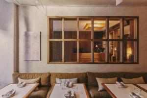 a restaurant with two tables and a couch at Hotel Casa Teva Barcelona in Barcelona +33 photos