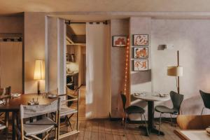a dining room with two tables and chairs at Hotel Casa Teva Barcelona in Barcelona +33 photos