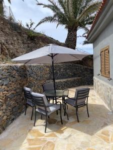 a table and chairs with an umbrella on a patio at Castaño II in Valle Gran Rey