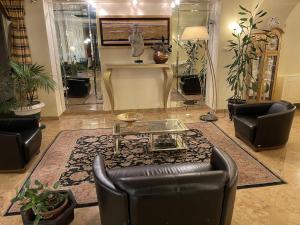 a living room with a couch and a table at Hotel Europa Fiera in Rho