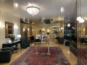 a lobby with a table and flowers in a room at Hotel Europa Fiera in Rho