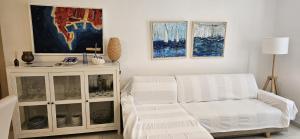 a living room with a white couch and a cabinet at Villa Pepo in Cavtat