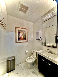 a bathroom with a toilet and a sink at Royal Oak Inn in Toronto +37 photos