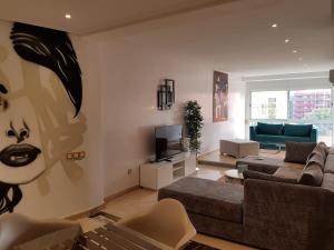 a living room with a couch and a tv at Urban Chic 2 bedrooms in Utimate City Center in Marrakech