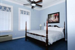 a bedroom with a bed and a ceiling fan at The Cisco Room in Eastland