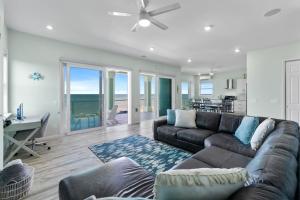 a living room with a couch and a table at Oceanshore Oasis in Flagler Beach