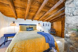 a bedroom with a bed and a stone wall at Log Cabin Retreat in Kentucky Fire Pit and Grill! in Owensboro