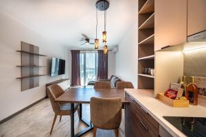 a kitchen and dining room with a table and chairs at Lana Del Capos in Saints Constantine and Helena