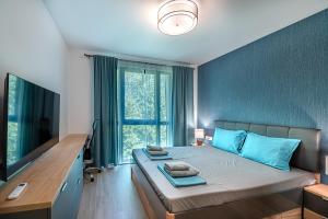 a bedroom with a bed with a desk and a television at Lana Del Capos in Saints Constantine and Helena