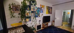 a living room with a book shelf and a tv at ArtApartment near Stephansplatz Stylish 2 Bedroom with AC in Vienna