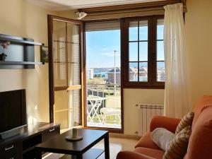 a living room with a couch and a large window at Cinco Soles - 5927 in Isla