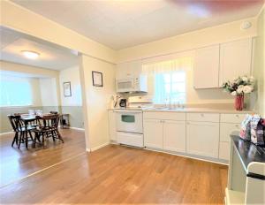a kitchen with white cabinets and a table with chairs at High - Family Neighborhood, Pet Friendly in Van Wert