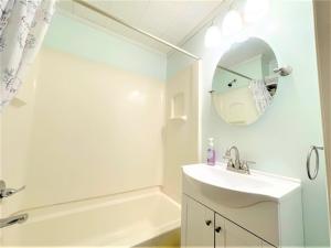 a bathroom with a sink and a tub and a mirror at High - Family Neighborhood, Pet Friendly in Van Wert