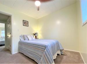 a bedroom with a bed in the corner of a room at High - Family Neighborhood, Pet Friendly in Van Wert +2 photos