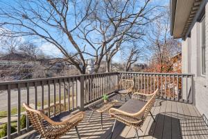 a balcony with four chairs and a table with a table at TWO Adjacent Homes in 12 South and Belmont area Sleeps 20 People in Nashville