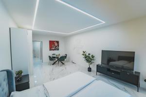 a bedroom with a bed and a tv and a table at Tessa&Aurora - Incredible Lake View & Pool with Parking in Lugano