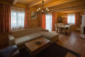 a living room with a couch and a table at Feriendorf Koralpe Chalet Edelweiss in St. Gertraud