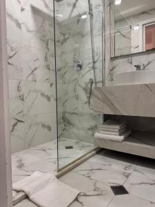 a bathroom with a glass shower and a sink at Very cozy 2 Room apart NEW GUDAURI, LOFT 2, apt 223 in Gudauri +25 photos