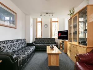 a living room with a couch and a table at PNJ Long Stay Central Manchester Accommodation in Manchester