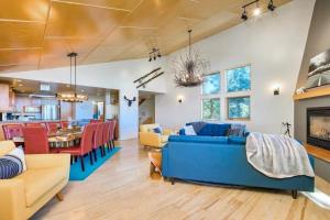 a living room with a blue couch and a dining room at Tahoe Donner Luxury 4BR, Hot tub 3100 sqft in Truckee
