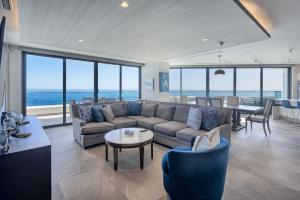 a living room with a couch and a table at LUXURY NEW OCEANFRONT CONDO 5BR Sleeps 12 in Puerto Peñasco