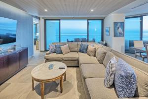 a living room with a couch and a table at LUXURY NEW OCEANFRONT CONDO 5BR Sleeps 12 in Puerto Peñasco +123 photos